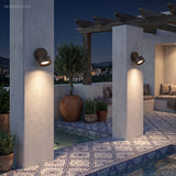 Two adjustable wall spots washing light down a rendered patio wall