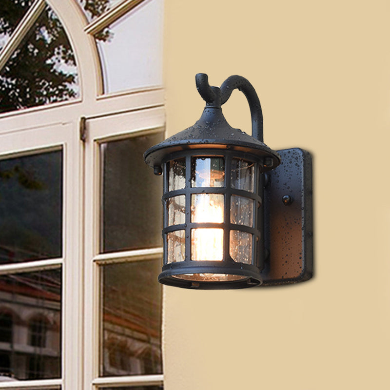 Lantern wall light on a cream wall beside an arched window