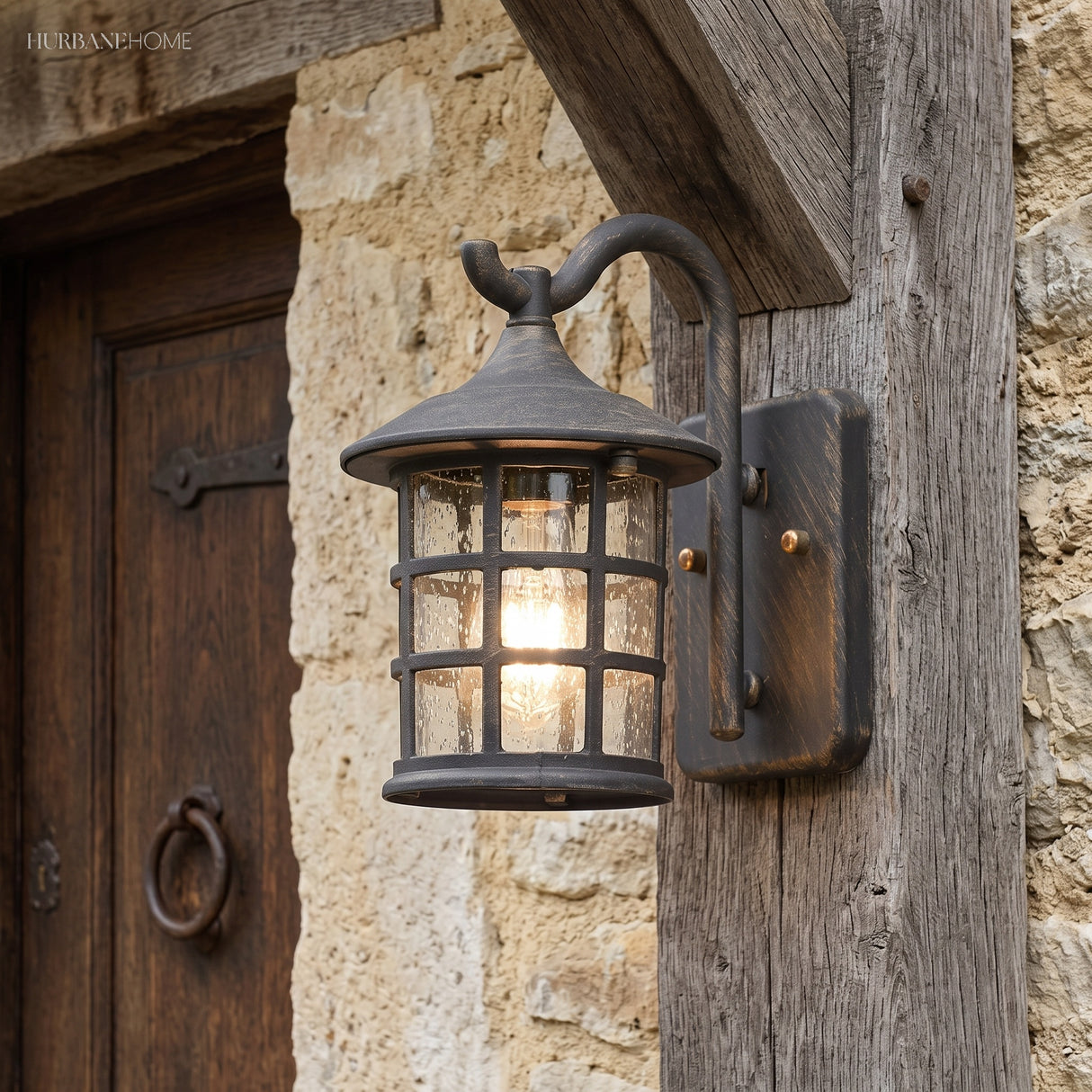 Lantern wall light on a sandstone wall beside a studded door