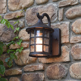 Lantern wall light mounted on a stone wall trailing with ivy