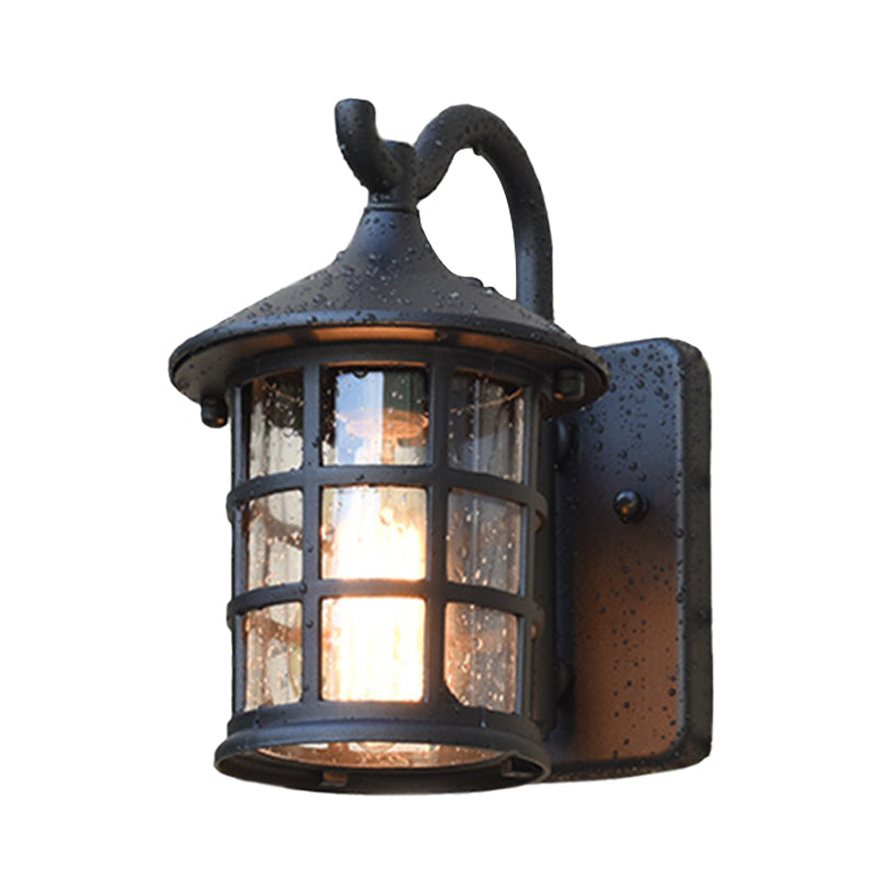 Seeded glass lantern with a scrolled arm shown against white