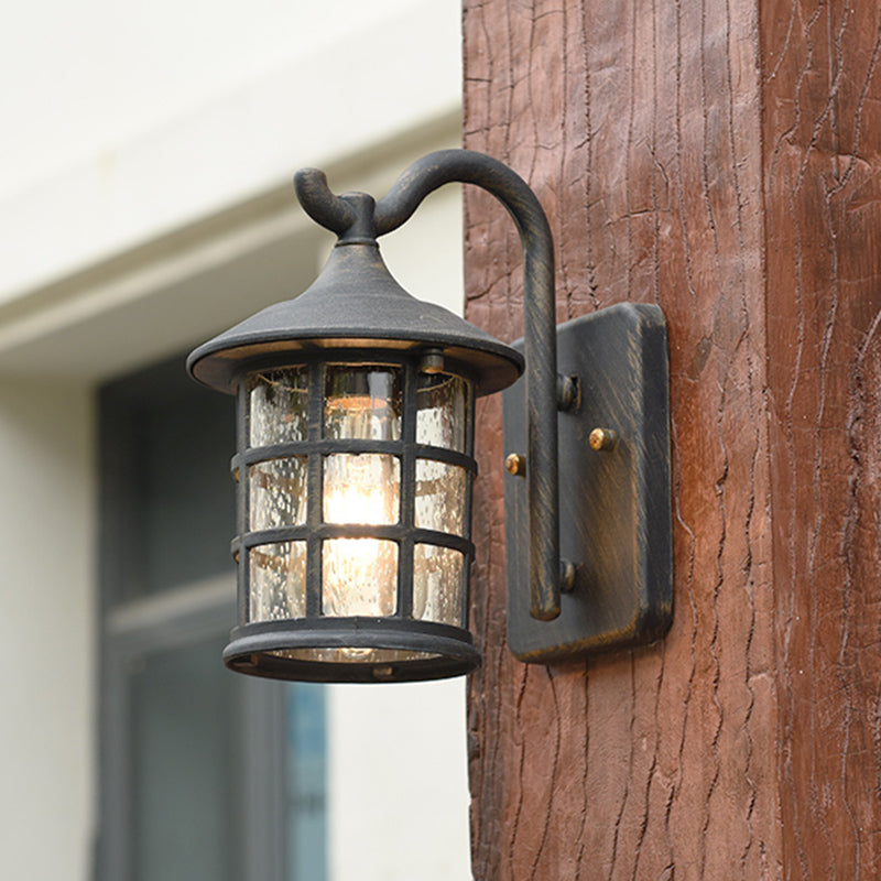 Lantern wall light mounted on a timber post beside a window