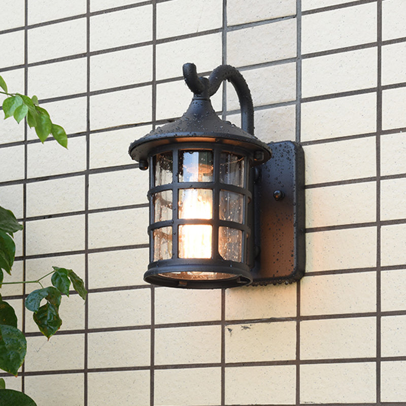 Lantern wall light on a white gridded wall with climbing ivy