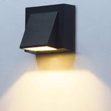 Close view of the wedge wall light casting a wide pool of light below