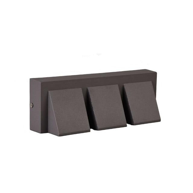 Dark grey three head outdoor wall light in a wide horizontal bar