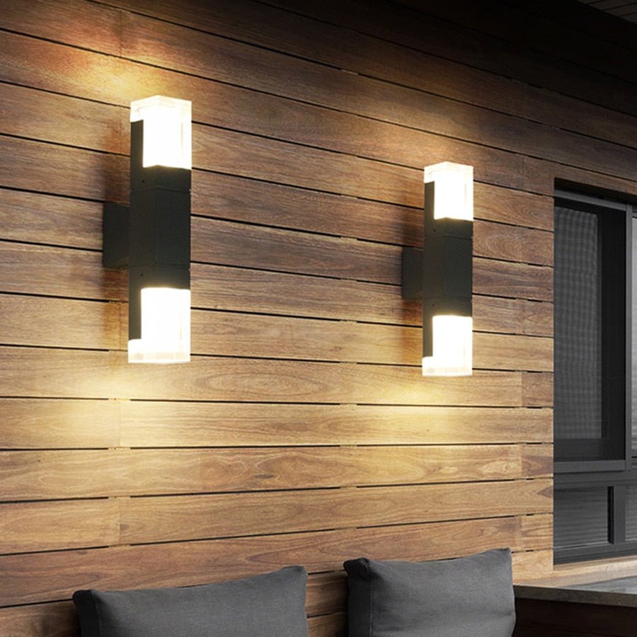 Two prism tube wall sconces lit on a horizontal timber clad wall