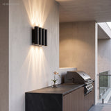 Two up and down sconces lighting a modern house exterior at dusk