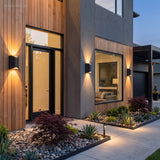 Rippled sconce beside a timber front door with beams above and below