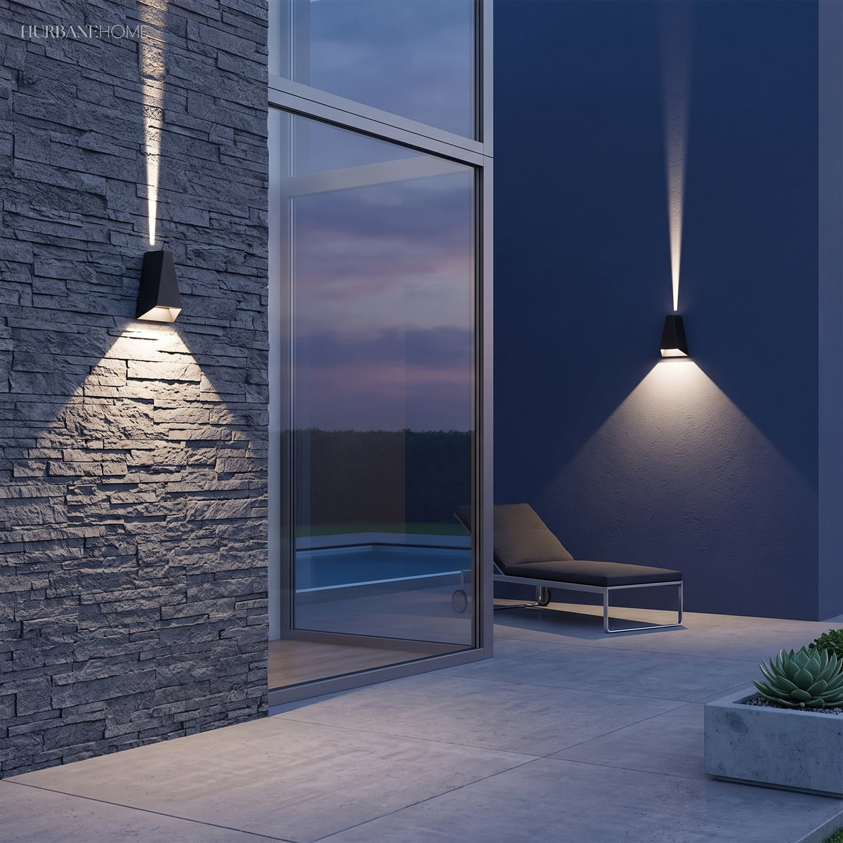 Outdoor sconce throwing a narrow beam up a dark wall beside glass doors