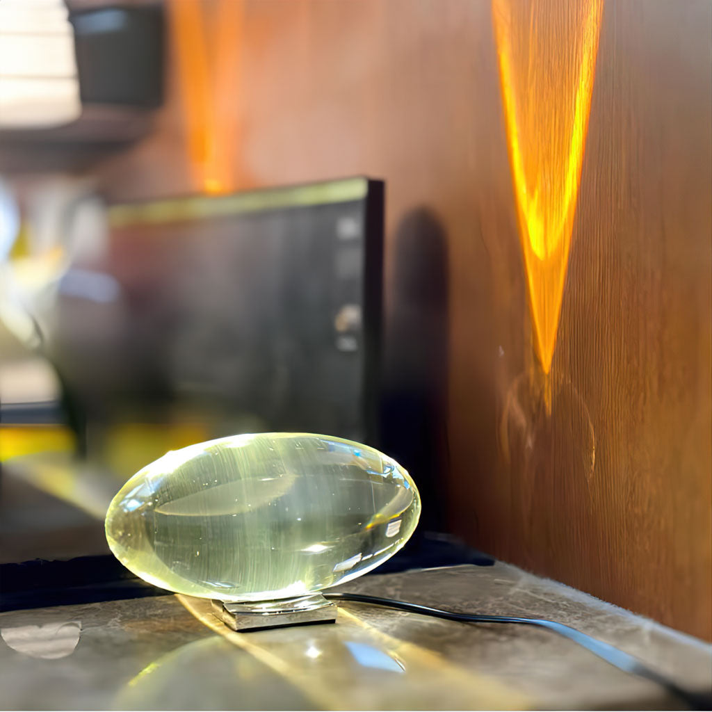 Modern oval glass lamp styled on a shelf as ambient decor