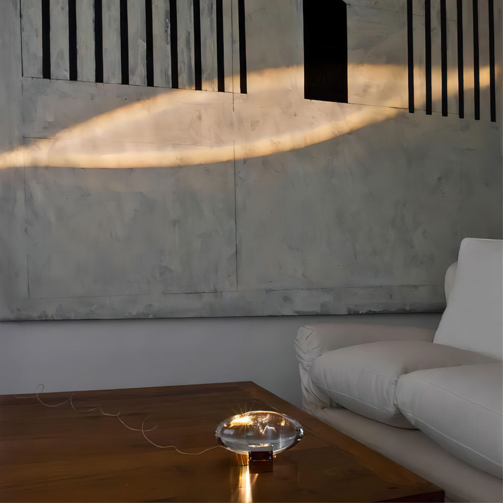 Oval glass mood lamp lit beside decor in a cosy setting