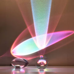 Side profile of oval glass ambient lamp showing polished body