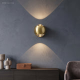 Modern Brass Wall Lamp Jorid Copper LED styled in a room setting