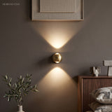 Modern Brass Wall Lamp Jorid Copper LED styled in a room setting