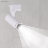 White adjustable spotlight head projecting a crisp downward beam