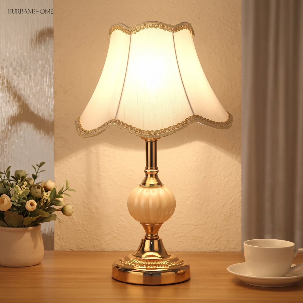 Gold base vintage table lamp with plain white shade and dried flowers