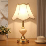 Gold base vintage table lamp with plain white shade and dried flowers