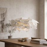 White folded paper pendant light hanging above a wooden dining table