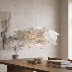 White folded paper pendant light hanging above a wooden dining table