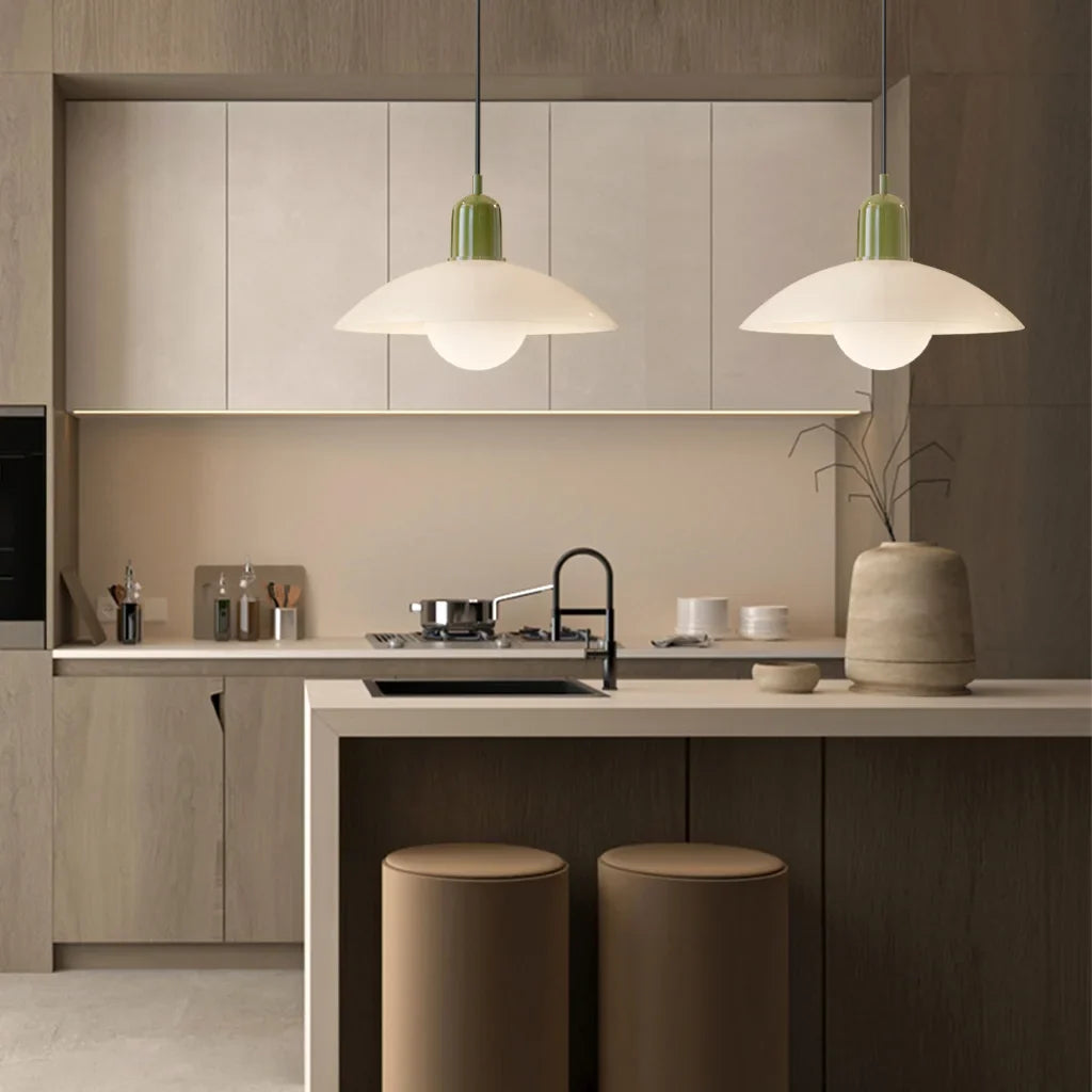 Green bodied pendant light with wide disc shade and glass globe