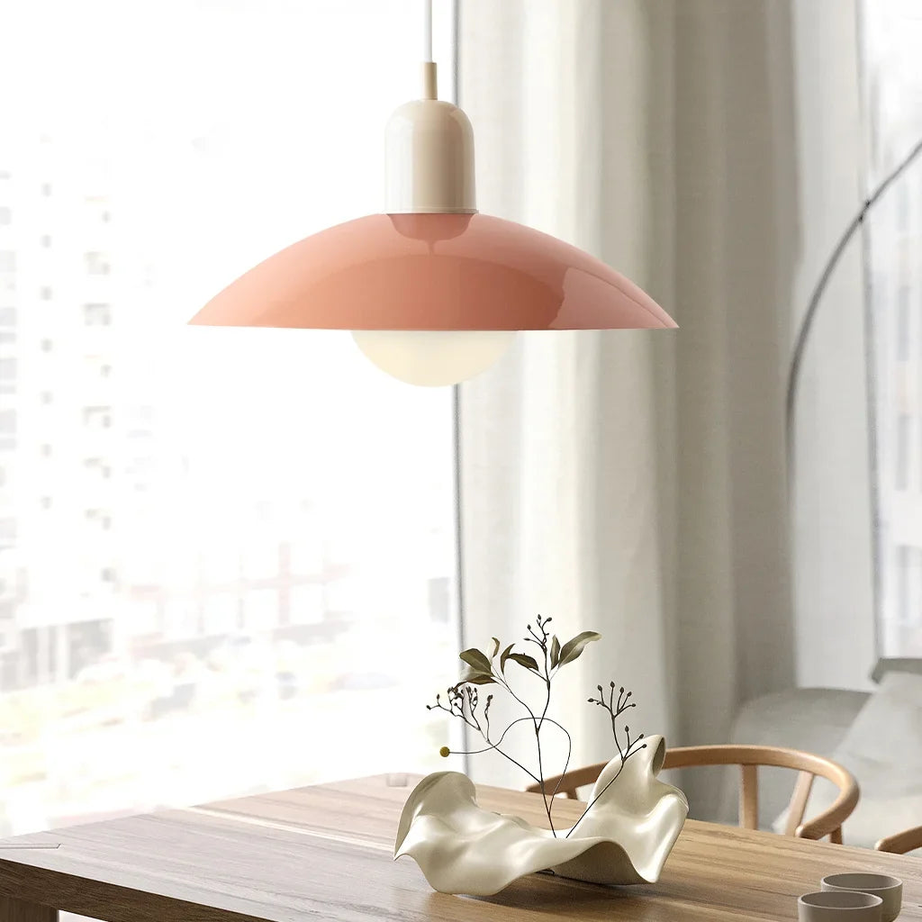 Pink coral pendant light with glossy metal disc shade and globe