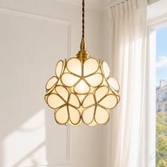 Detail of brass frame holding overlapping engraved glass petals on the pendant