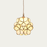 Brass hardware and petal glass shade of the pendant light in detail