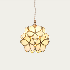 Brass hardware and petal glass shade of the pendant light in detail