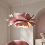 Pink petal pendant light lit in a beige room with an arch
