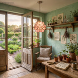 Pink petal glass pendant light glowing in a green garden potting room