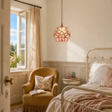 Pink petal glass pendant light shown lit on a plain studio background