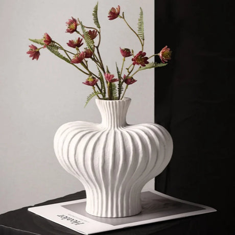 Plastic flower vase styled as minimalist table centerpiece