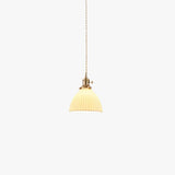 Pleated white ceramic pendant light with a brass lamp fitting, view 1