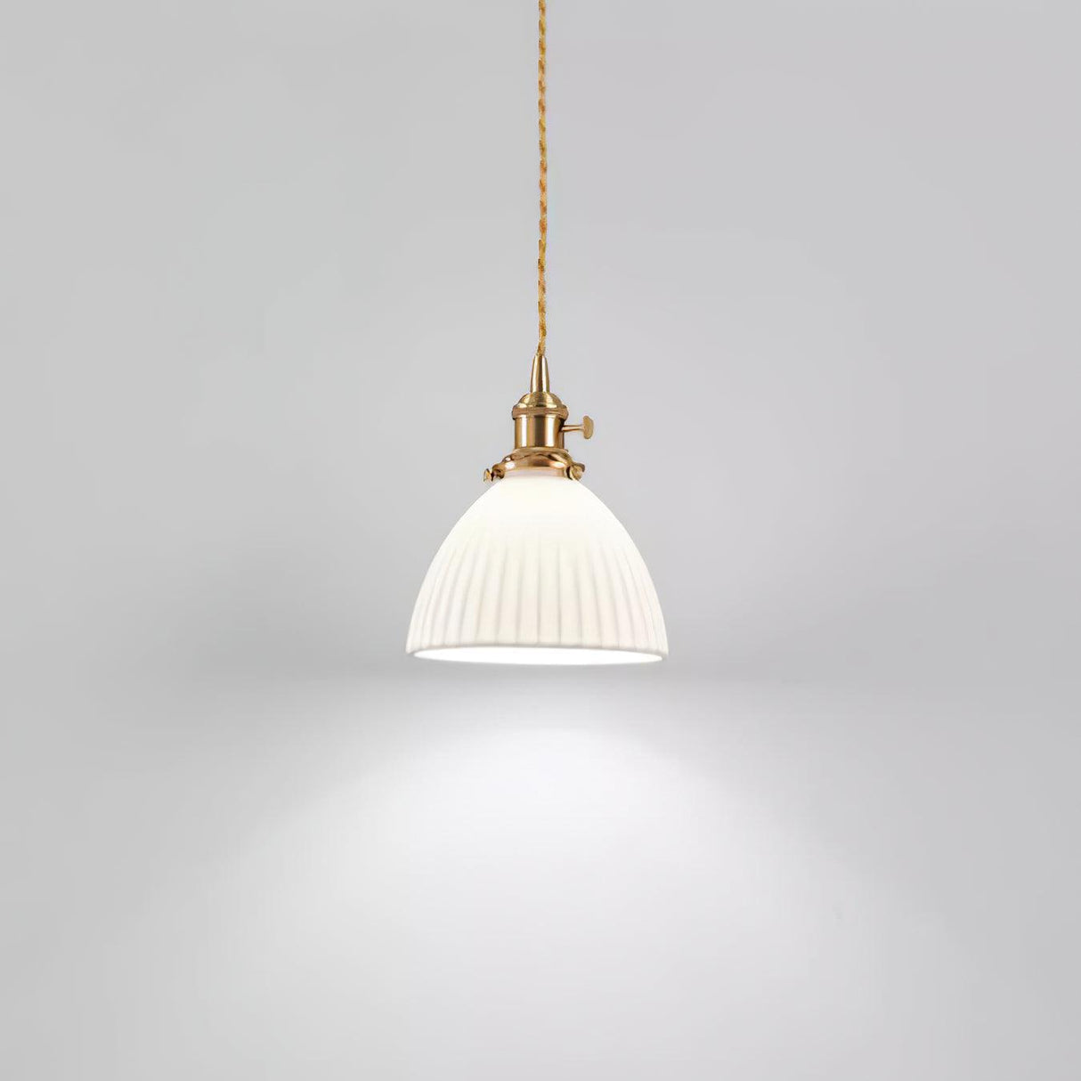 Pleated white ceramic pendant light with a brass lamp fitting, view 13