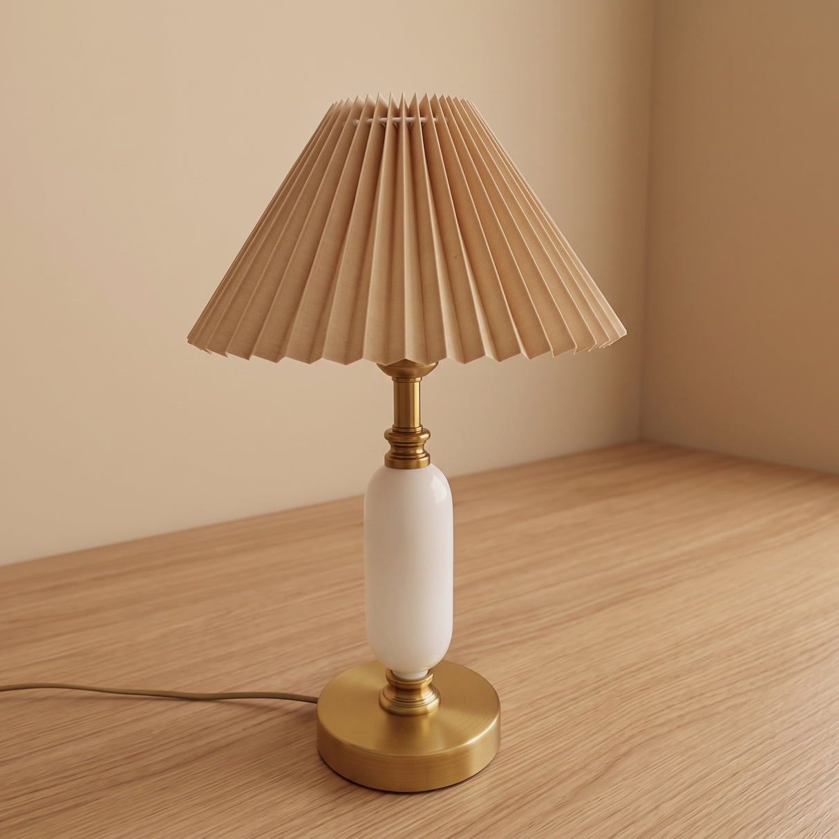 Khaki pleated shade table lamp with brass base on a wood floor