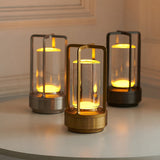 Three lamps in silver, gold and black lit together on a white surface