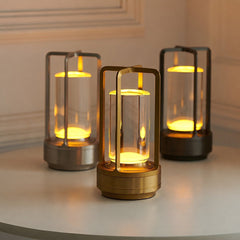 Three lamps in silver, gold and black lit together on a white surface