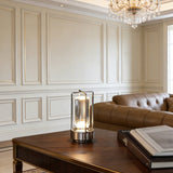 Silver cordless lamp on a dark wood table in a panelled sitting room