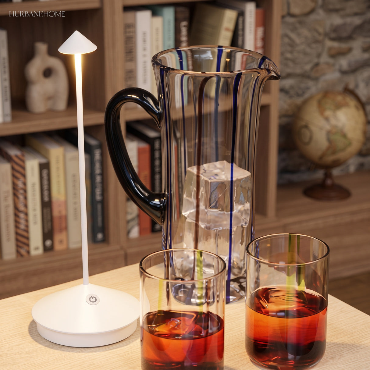 White portable LED table lamp beside a glass jug of iced drink