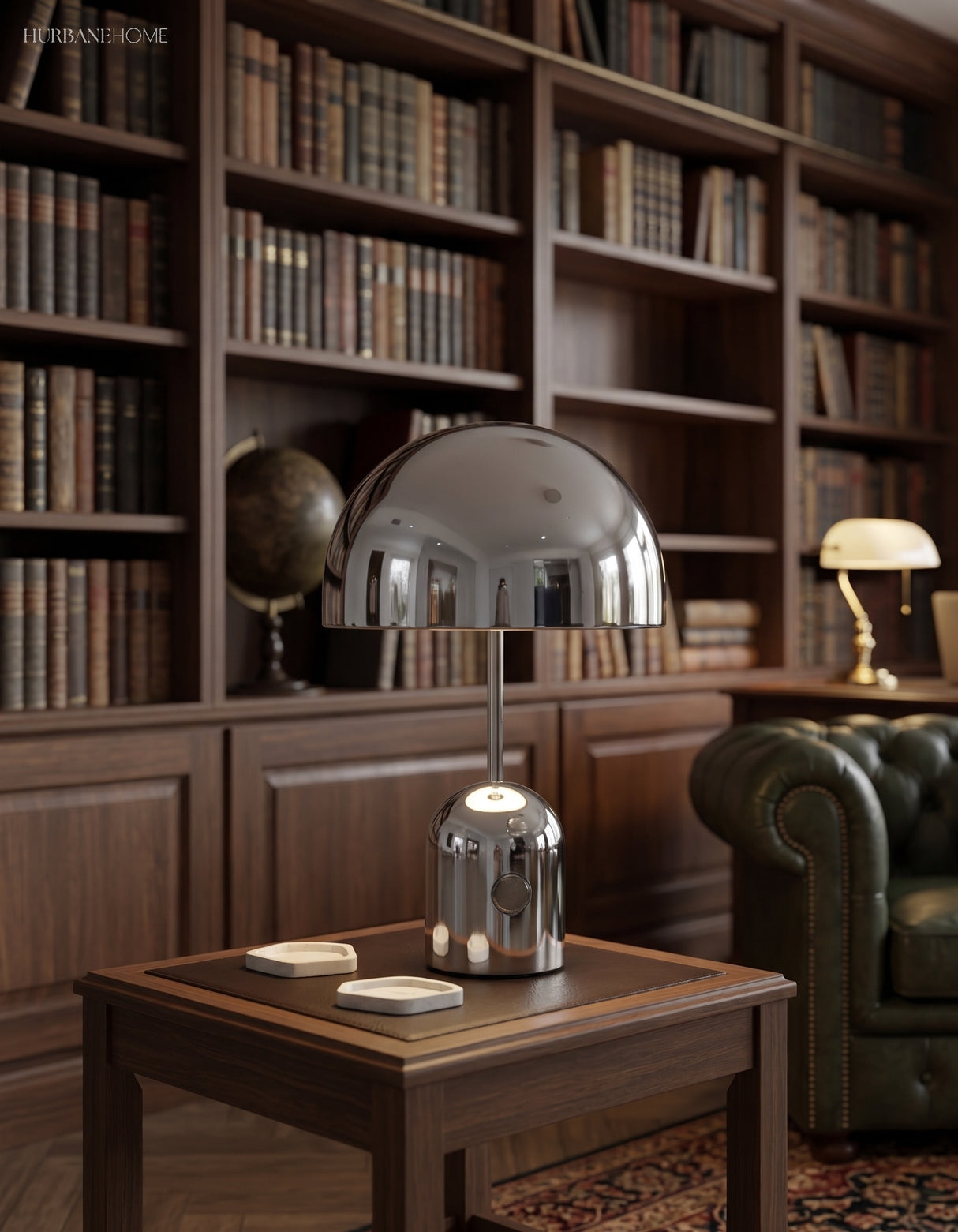 Chrome dome table lamp lit on a side table in a dark panelled library