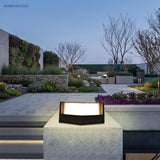 Aluminium post cap outdoor landscape light in a garden setting