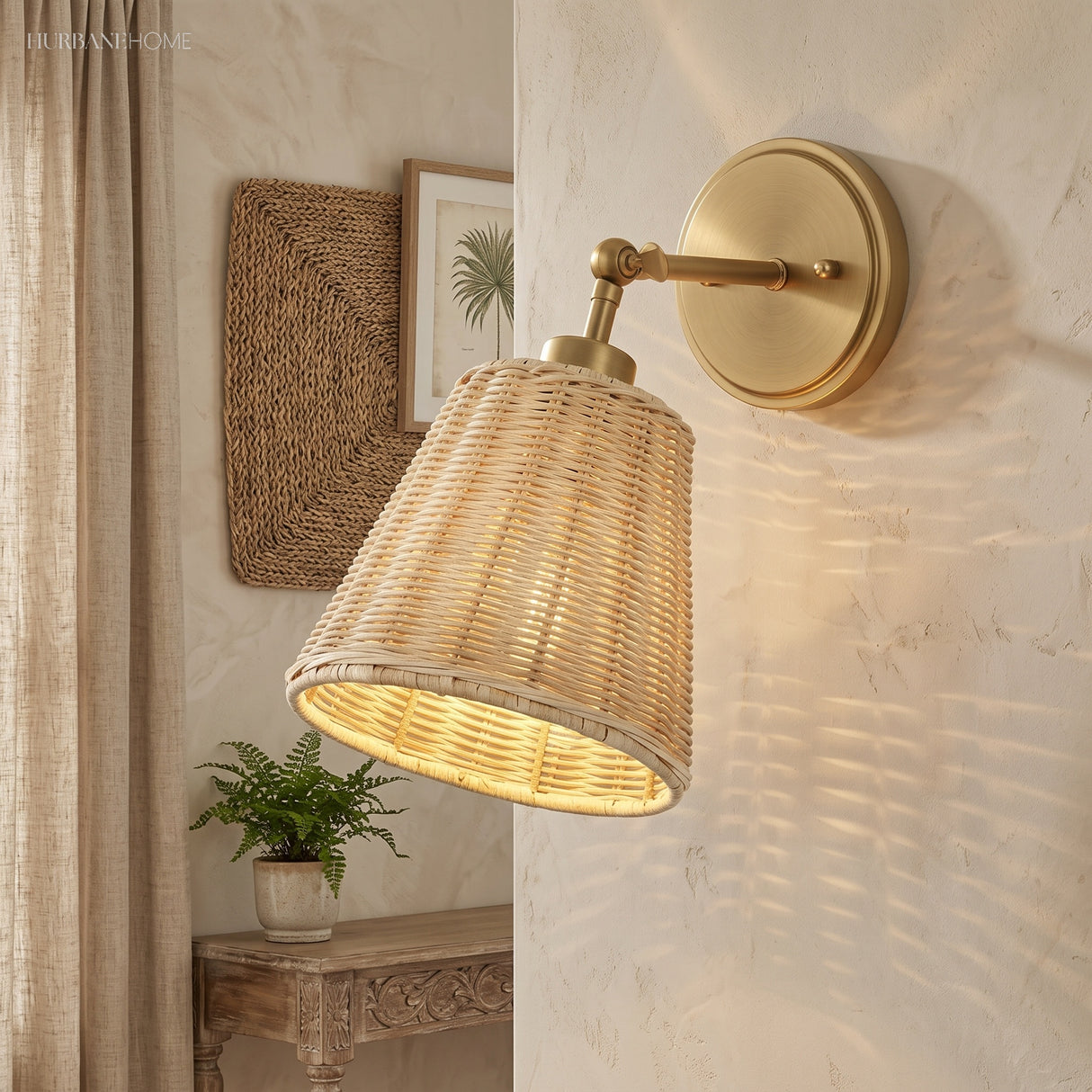 Rattan cone sconce on a brass arm casting patterned light on plaster