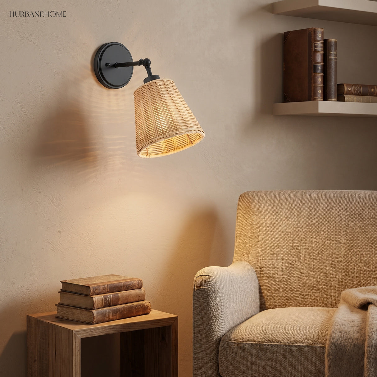 Black swing arm rattan sconce above books and a cream armchair