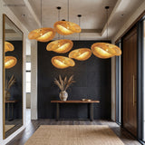 Row of woven bamboo pendant lights along a dark panelled entry hall