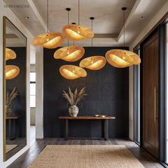 Row of woven bamboo pendant lights along a dark panelled entry hall