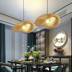 Bamboo pendant lit low over a timber tea table and stools