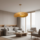 Rattan saucer pendant hung alone in a plain white room