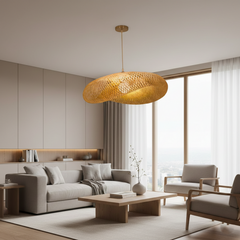 Rattan saucer pendant hung alone in a plain white room