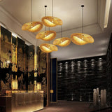 Bamboo pendant lights in a row above a long restaurant table