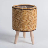 Rattan planter on legs styled in modern living room